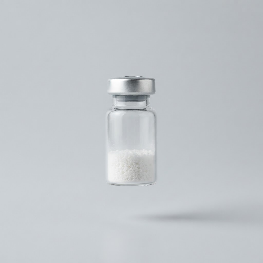 A clear glass vial containing a white freeze dried powder cake
